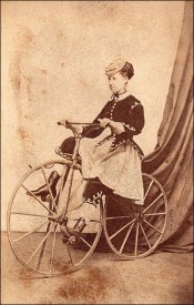 Senhora usando roupas de equitação em sua bicicleta, 1869.